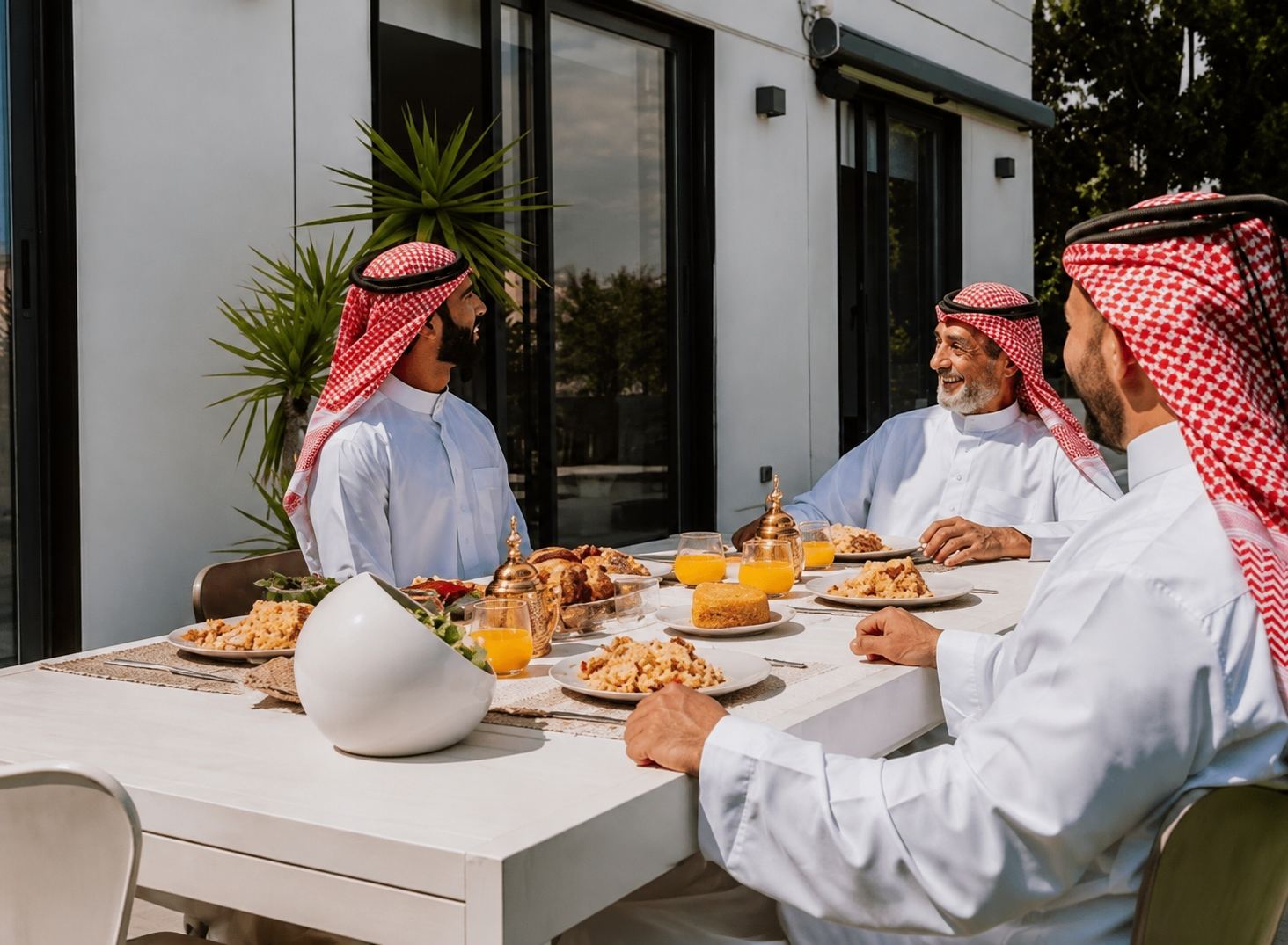 Guests gathered around a walimah table sharing a freshly prepared feast